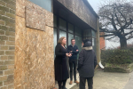 Faye Purbrick and Cllr Tom Power talking to a resident outside a boarded up shop on Wincanton High Street